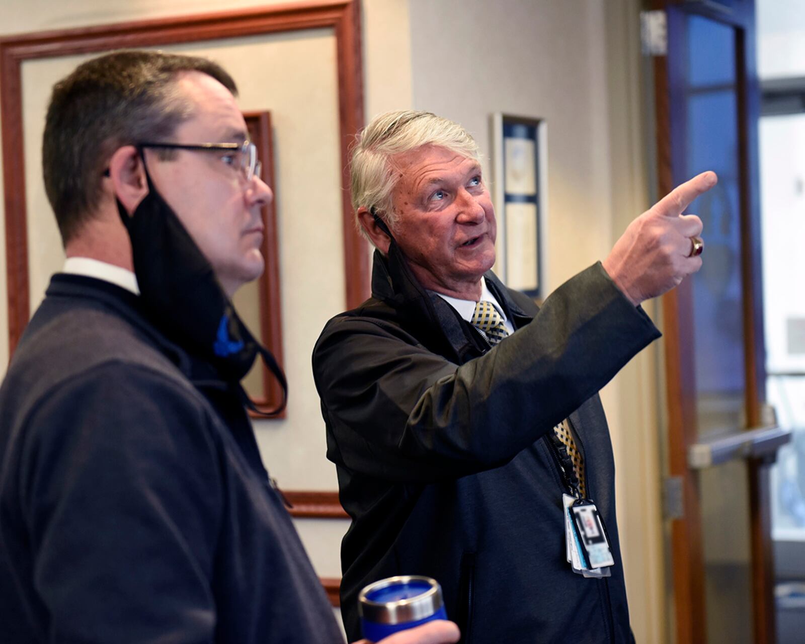 Dave Egner (right), the 88th Operations Support Squadron’s director of special operations, talks with his successor, John Vance, inside the Base Ops building at Wright-Patterson Air Force Base on March 2. Egner is retiring from the Air Force after more than 40 years at Wright-Patt. U.S. AIR FORCE PHOTO/TY GREENLEES