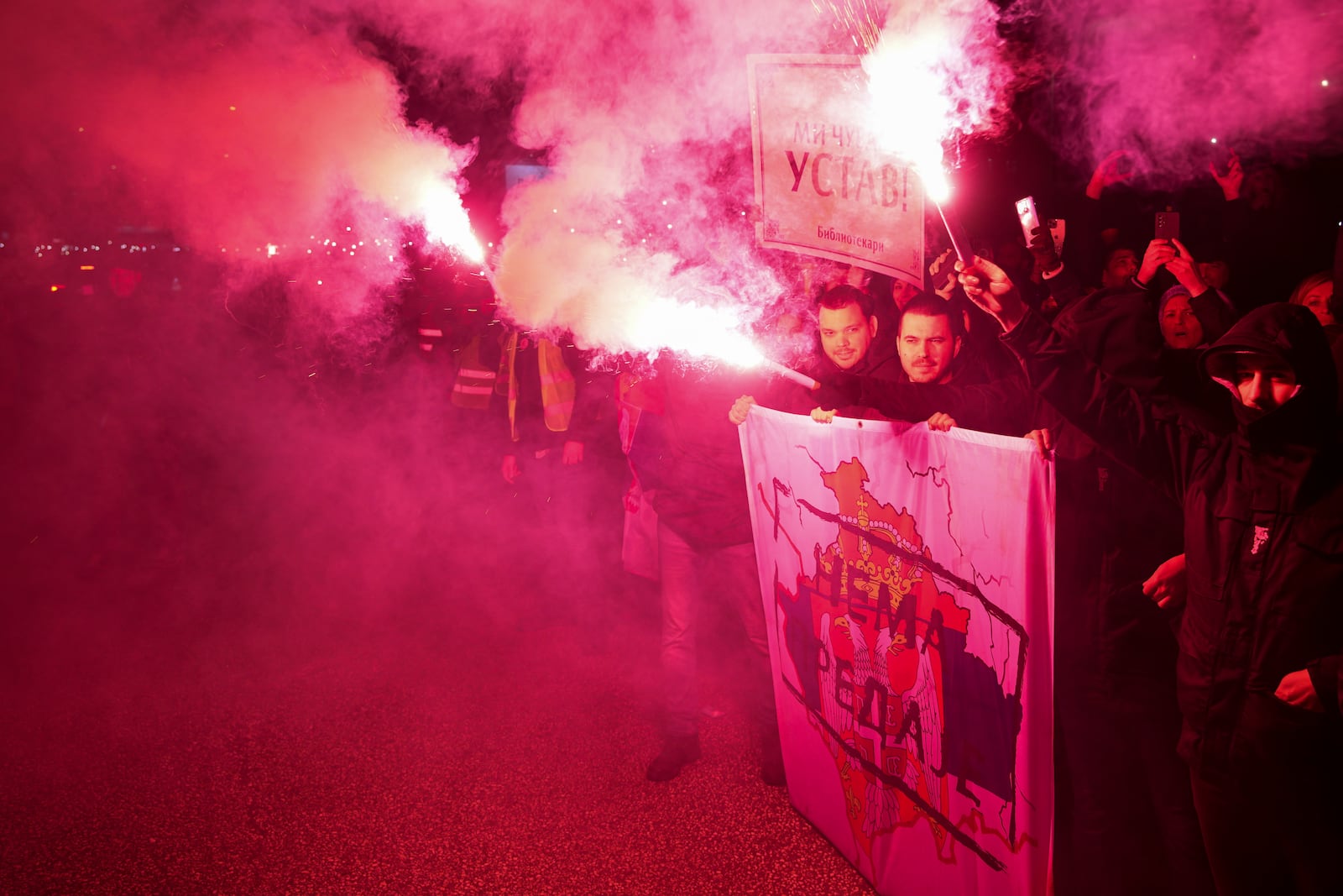 People welcome students in the Serbian industrial town of Kragujevac, who have arrived to protest the deaths of 15 people killed in the November collapse of a train station canopy, Friday, Feb. 14, 2025. (AP Photo/Darko Vojinovic)