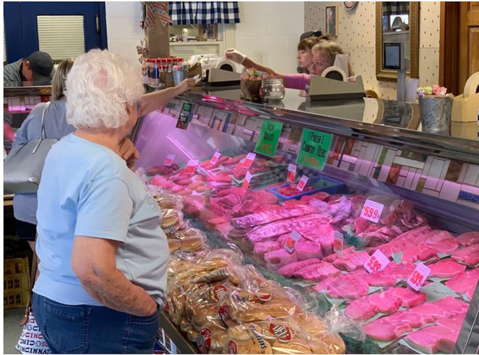 A customer looks over the selection of meat at the Dale Zink Meat Market in Franklin on Thursday June 30, 2022. Pete Zink runs the family-owned business and said business has been going nonstop and expects it to continue. While the costs of bacon and boneless chicken breast are up 30% and steak products are up 20%, Zink said people are still coming in to buy meat and chicken.         ED RICHTER/STAFF