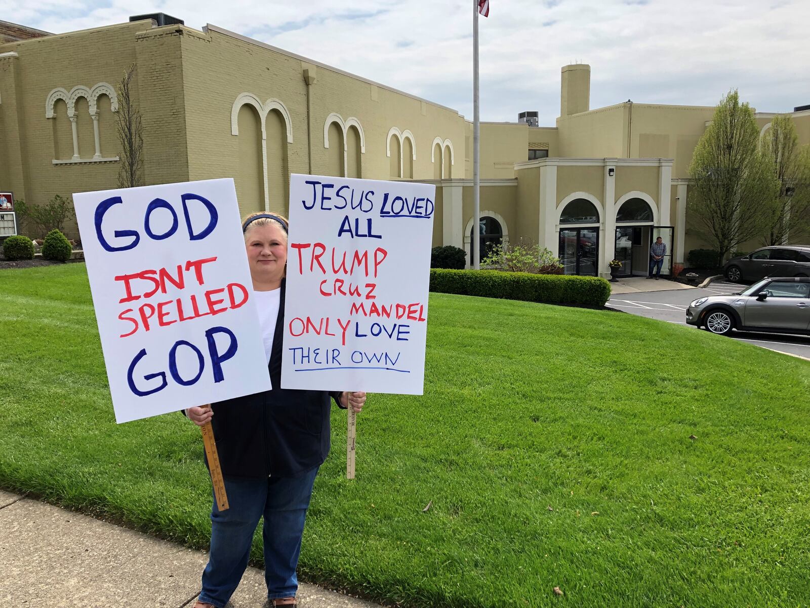 Jennifer Alexander, 50, of Montgomery County protests outside a rally held by Josh Mandel with U.S. Sen. Ted Cruz, R-TX, at Victory Christian Church in Kettering