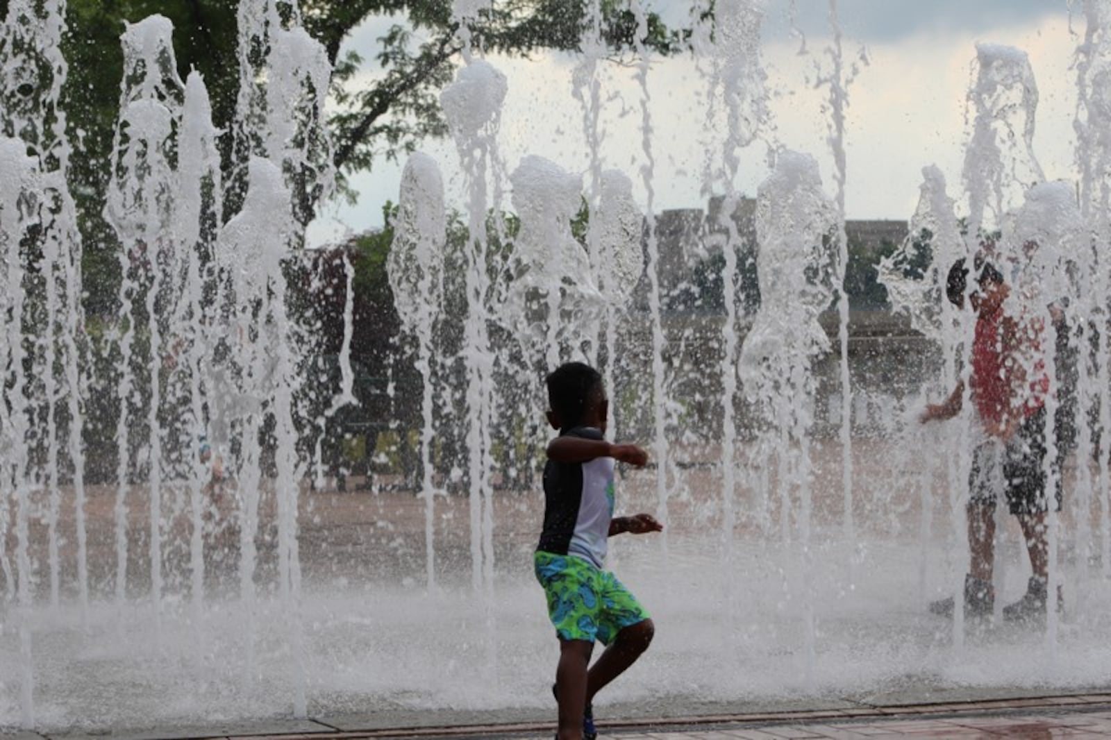 Children play in the water fountain at RiverScape MetroPark in downtown Dayton.