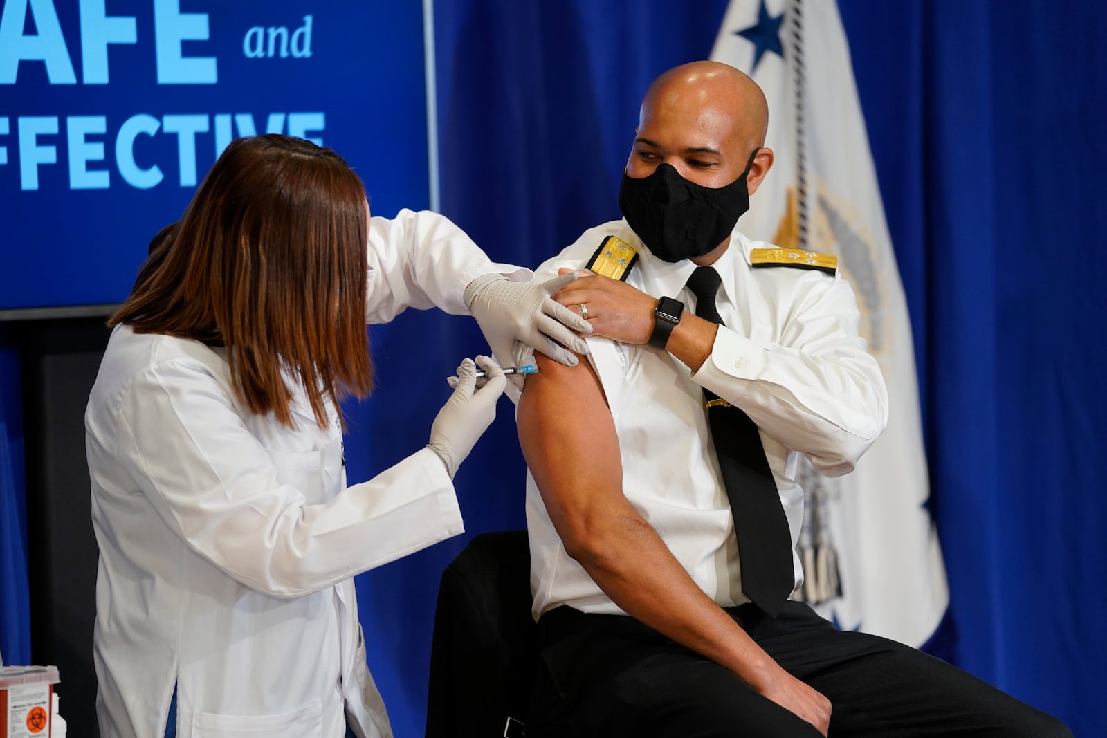 U.S. Surgeon General Jerome Adams receives a Pfizer-BioNTech COVID-19 vaccine at the White House in Washington on Friday, Dec, 18, 2020. Vice President Mike Pence also received a coronavirus vaccine at the event broadcast on live television, a measure that the Trump administration said was intended to "promote the safety and efficacy of the vaccine and build confidence among the American people." (Doug Mills/The New York Times)