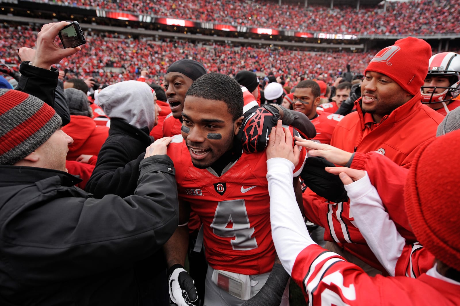 COLUMBUS, OH - NOVEMBER 24:  C.J. Barnett #4 of the Ohio State Buckeyes is congratulated by fans after Ohio State defeated the Michigan Wolverines 26-21 at Ohio Stadium on November 24, 2012 in Columbus, Ohio.  (Photo by Jamie Sabau/Getty Images)