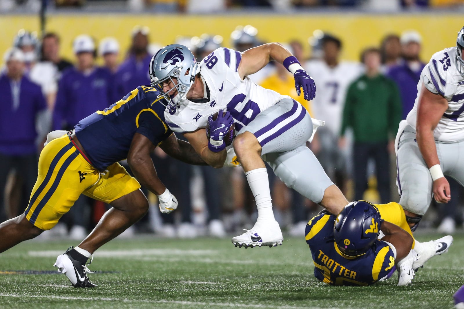 Kansas State tight end Garrett Oakley (86) is tackled by West Virginia linebacker Josiah Trotter (40) during the frist half of an NCAA college football game, Saturday, Oct. 19, 2024, in Morgantown, W.Va. (AP Photo/William Wotring)