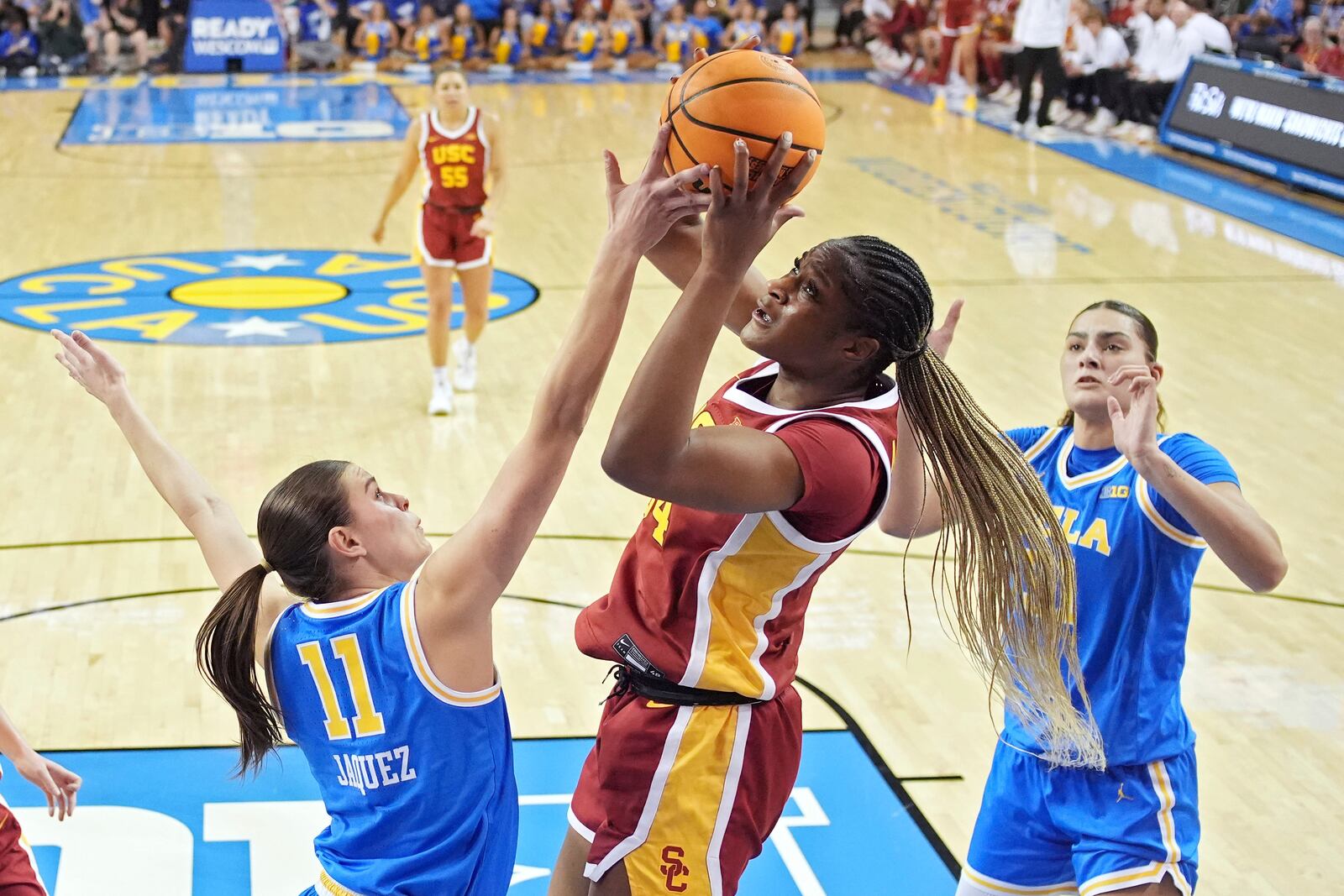 Southern California center Clarice Akunwafo, center, shoots as UCLA guard Gabriela Jaquez, left, and center Lauren Betts defend during the first half of an NCAA college basketball game Saturday, March 1, 2025, in Los Angeles. (AP Photo/Mark J. Terrill)