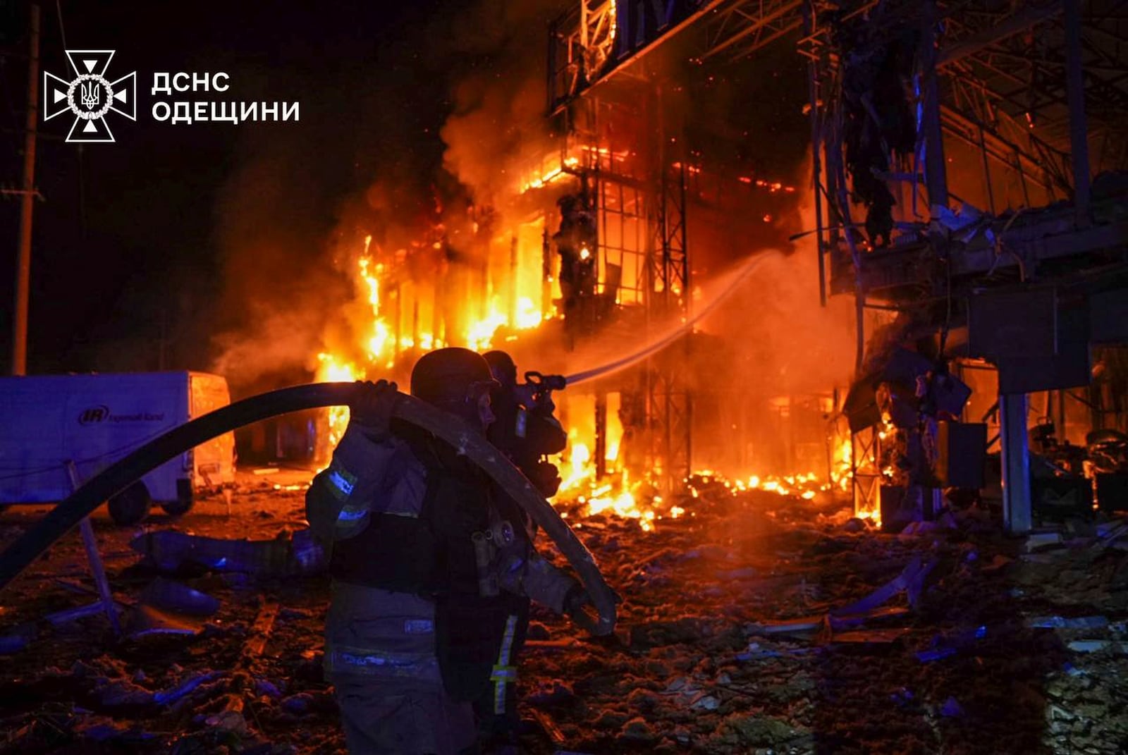 In this photo provided by the Ukrainian Emergency Service, firefighters put out the fire at a storehouse following a Russian attack in Odesa, Ukraine, Friday, March 21, 2025. (Ukrainian Emergency Service via AP)