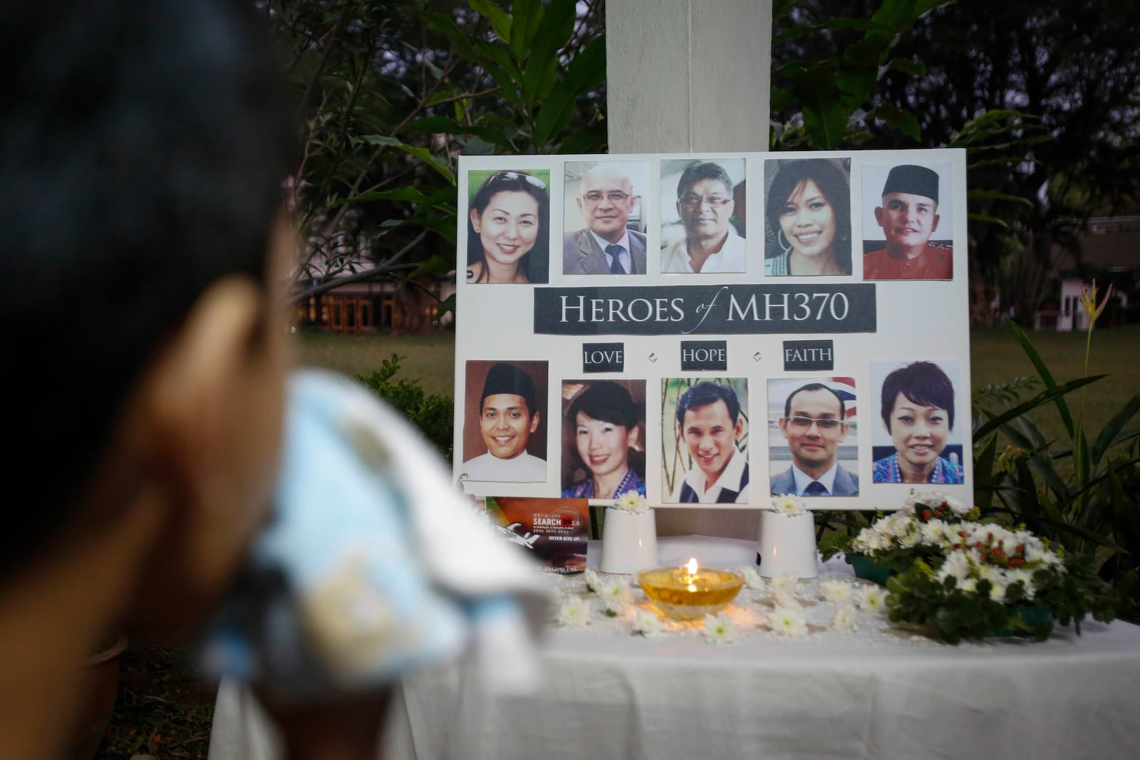 FILE - A Malaysian boy wipes his tears during a special prayer for the ill fated Malaysia Airlines Flight 370 at a church in Kuala Lumpur, Malaysia, Tuesday, March 8, 2016. (AP Photo/Joshua Paul,File)