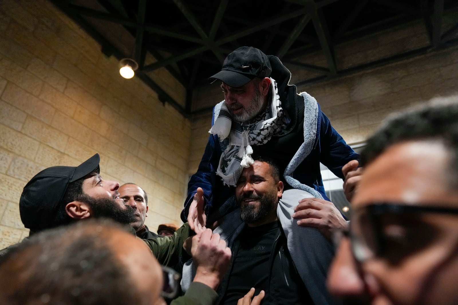 Palestinian prisoners are greeted after being released from Israeli prison following a ceasefire agreement between Israel and Hamas, in the West Bank city of Ramallah, Thursday, Feb. 27, 2025. (AP Photo/Nasser Nasser)