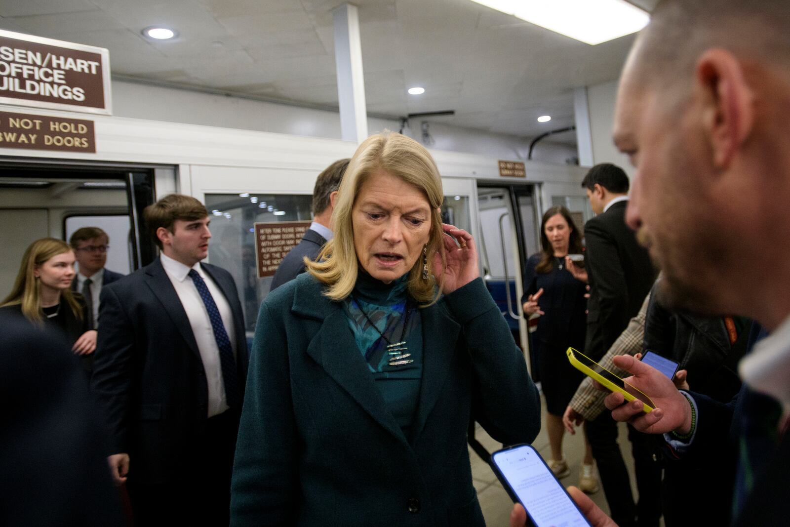 Sen. Lisa Murkowski, R-Alaska, talks with reporters as she makes her way through the Senate subway, Thursday, Jan. 23, 2025, in Washington. (AP Photo/Rod Lamkey, Jr.)