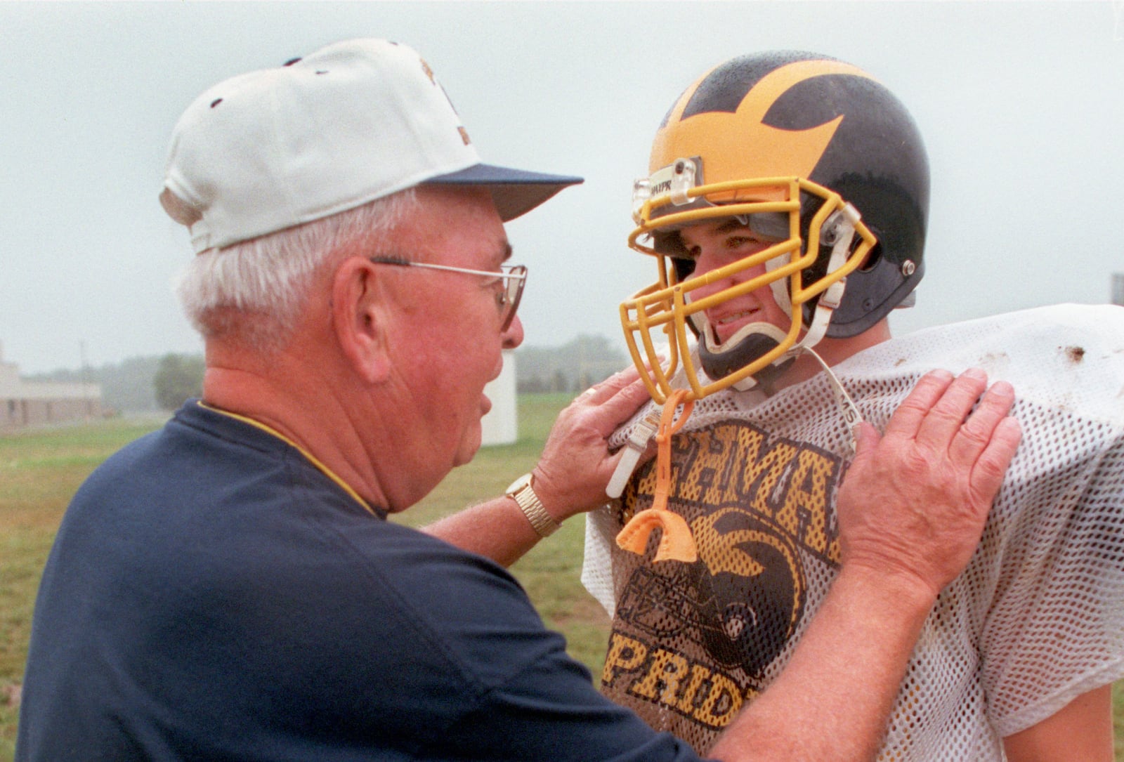 08-20-1997 Sidney Lehman Hign School football coach Chuck Asher, 67, works with his team Wednesday, teaching plays for the fall season. He is a veteran of 40 to 45 years in high school football. This year he is coaching his grandson, Brian Williamson