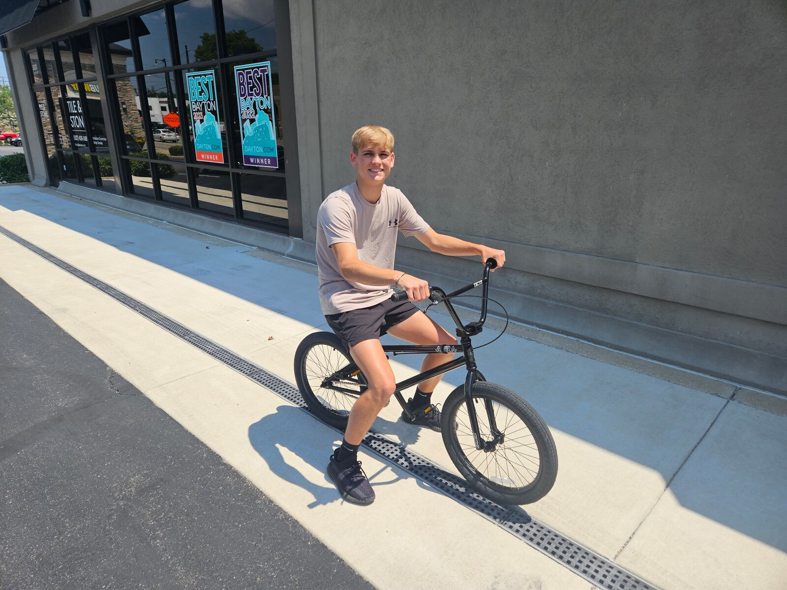 Jonah Shreves with his new bike in front of Drytech Exteriors. JESSICA GRAUE/CONTRIBUTED