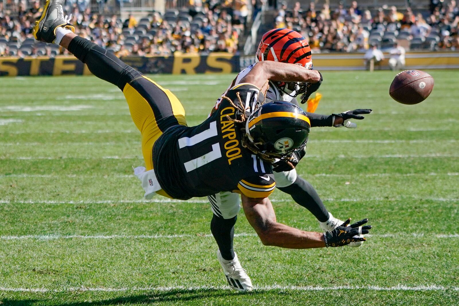 A penalty flag flies behind Pittsburgh Steelers wide receiver Chase Claypool (11) as he can't make a catch of a pass as Cincinnati Bengals cornerback Eli Apple (20) defends during the second half an NFL football game, Sunday, Sept. 26, 2021, in Pittsburgh. Apple was called for pass interference on the play. The Bengals won 24-10. (AP Photo/Gene J. Puskar)