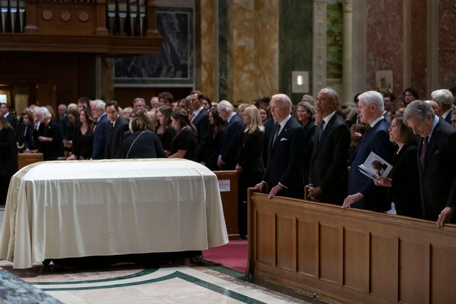 From left in pew, President Joe Biden, former President Barack Obama, former President Bill Clinton, and former Speaker of the House of Representatives Nancy Pelosi, attend a memorial service for Ethel Kennedy, the wife of Sen. Robert F. Kennedy, who died Oct. 10, 2024, at age 96, at the Cathedral of St. Matthew the Apostle in Washington, Wednesday, Oct. 16, 2024. (AP Photo/Ben Curtis)