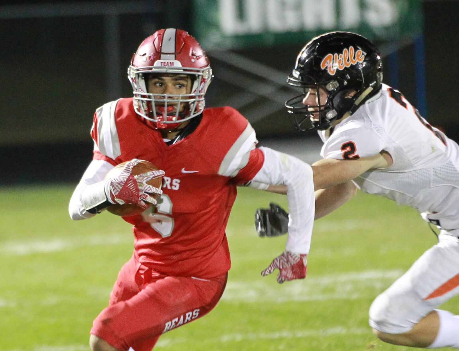 Darryl Story Jr. of Northridge (with ball) eludes Zane Blasidell. Waynesville defeated host Northridge 23-8 in a Week 9 high school football game on Thursday, Oct. 24, 2019. MARC PENDLETON / STAFF