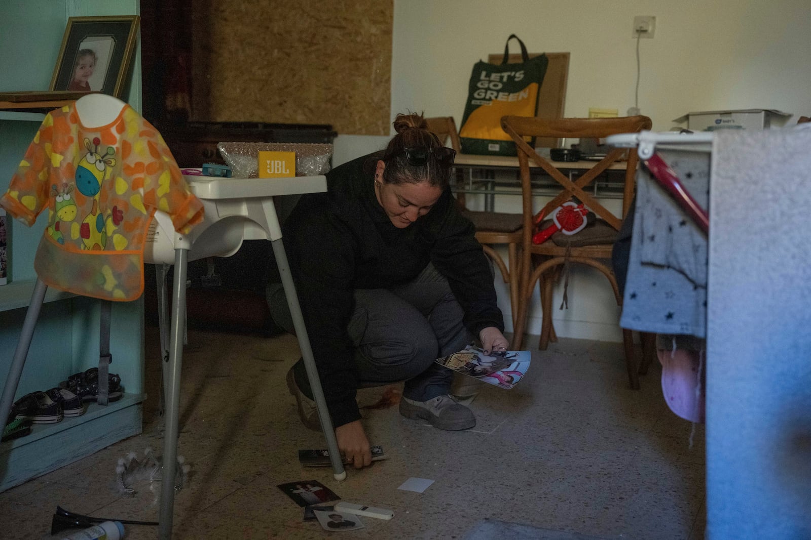 Inbal Limor, an Israeli displaced by the Israel-Hezbollah conflict, returns to her home in Kibbutz Manara to clean and organize after the ceasefire, in northern Israel, Monday Dec. 2, 2024. (AP Photo/Ohad Zwigenberg)