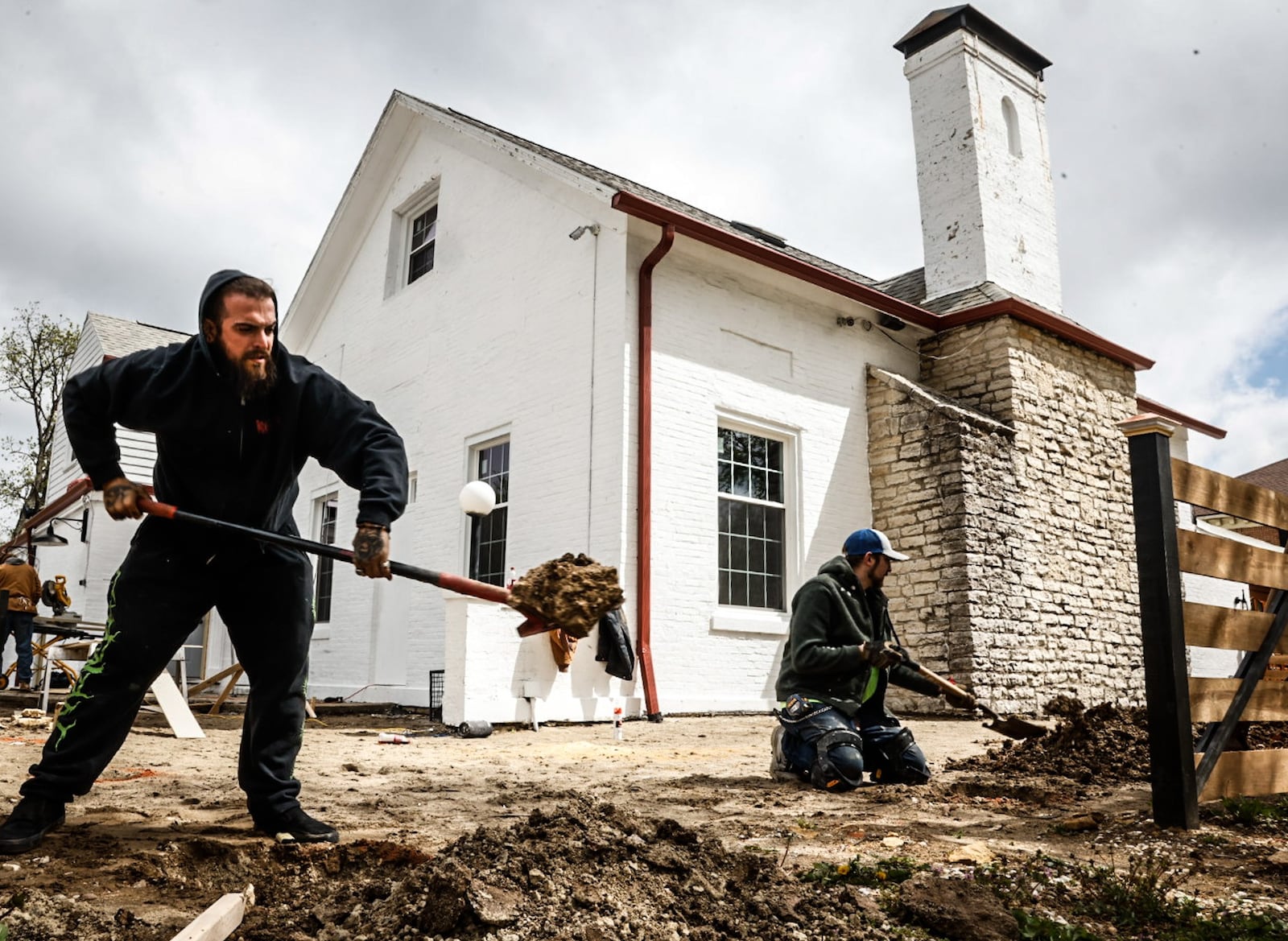 Matt Tyndell (left) and Jeremy Vincent, of Vincent Construction & Landscaping, work on streetscape improvements for the Brunch Pub on West Franklin Street Wednesday, May 3, 2023. City officials say the Centerville Community Improvement Corporation's Uptown Upgrades program has been vital for the redevelopment of the area. JIM NOELKER/STAFF