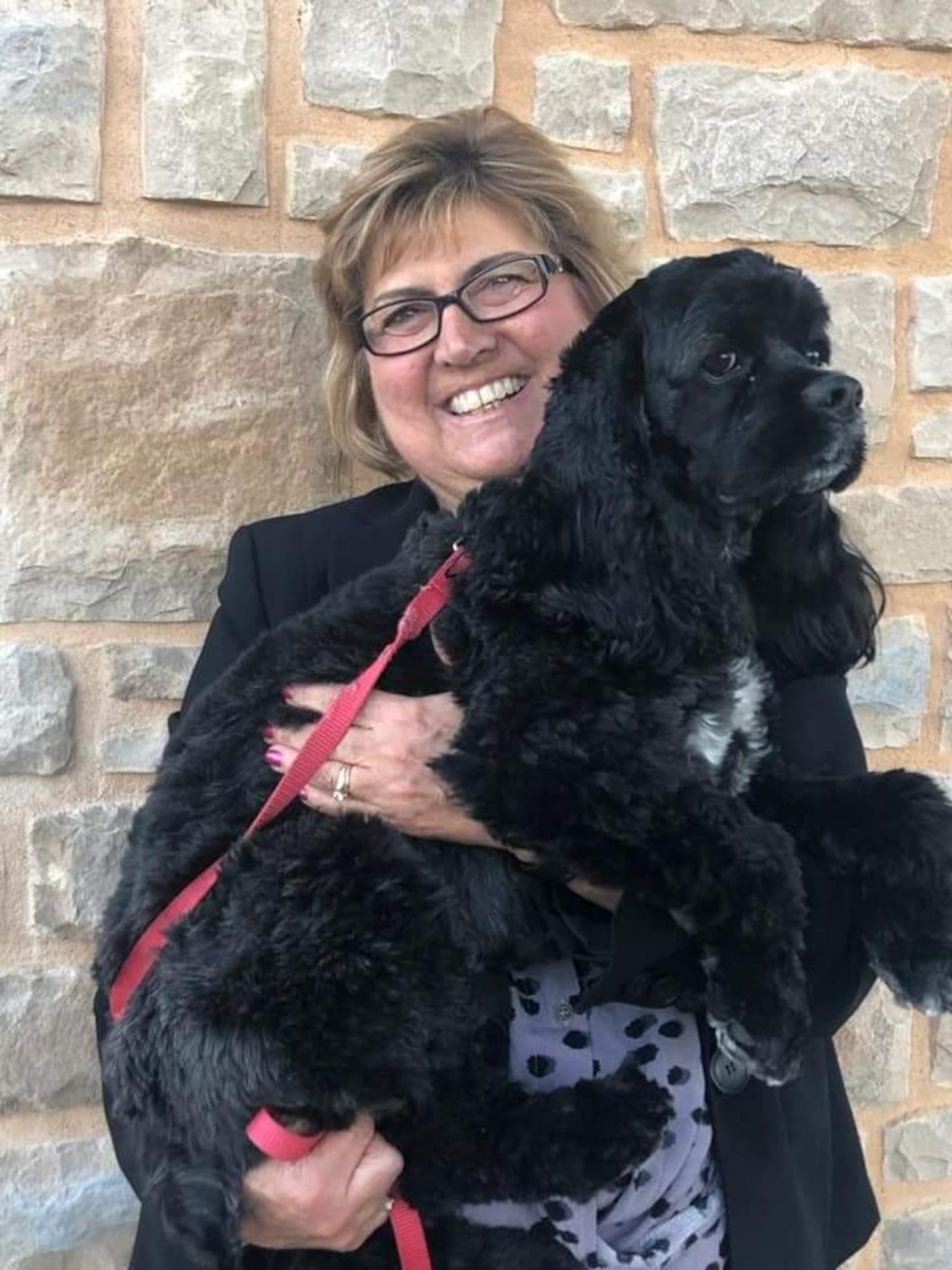 Volunteer Wendy Cole holds her therapy animal CoCo. CONTRIBUTED