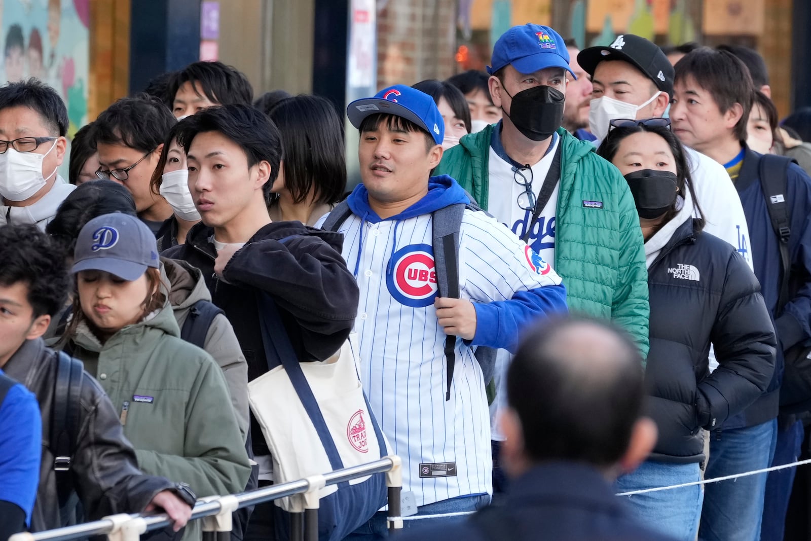 Fans of the Chicago Cubs and the Los Angeles Dodgers walk around the Tokyo Dome ahed of an MLB Tokyo Series baseball game between the Los Angeles Dodgers and the Chicago Cubs, in Tokyo, Tuesday, March 18, 2025. (AP Photo/Shuji Kajiyama)