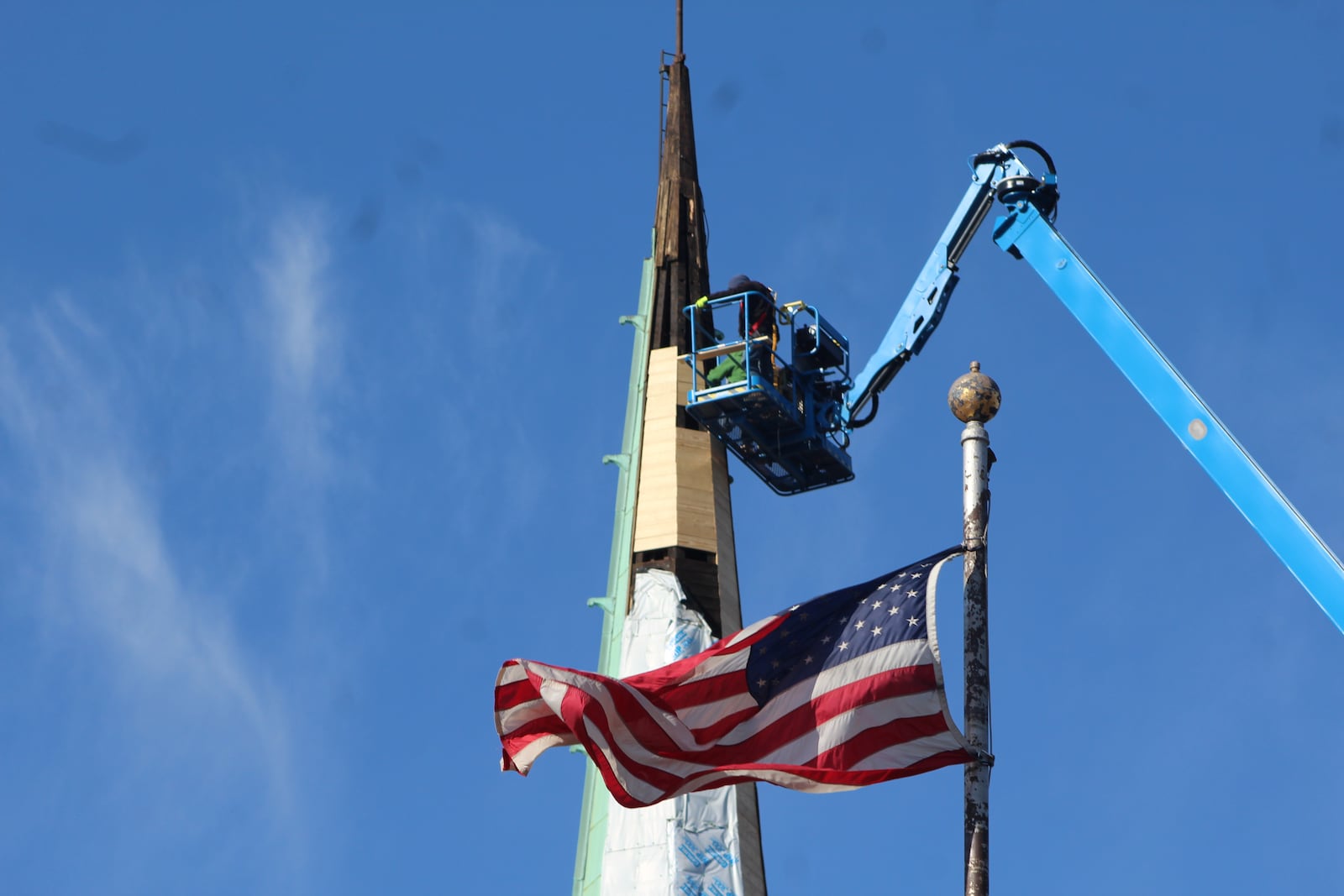 A crew works on a church spire in downtown Dayton in November 2023. Construction work has some safety risks. CORNELIUS FROLIK / STAFF