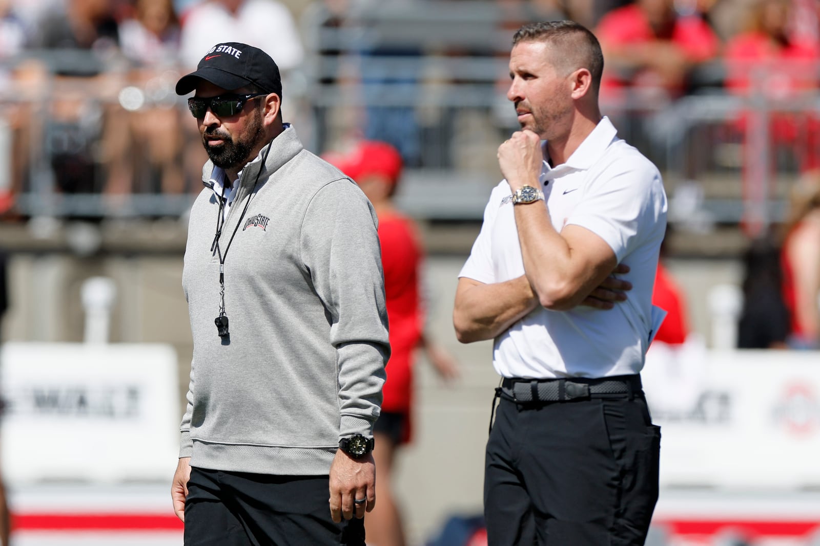 Ohio State head coach Ryan Day, left, and offensive coordinator Brian Hartline watch their team during their spring NCAA college football game, Saturday, April 15, 2023, in Columbus, Ohio. (AP Photo/Jay LaPrete)