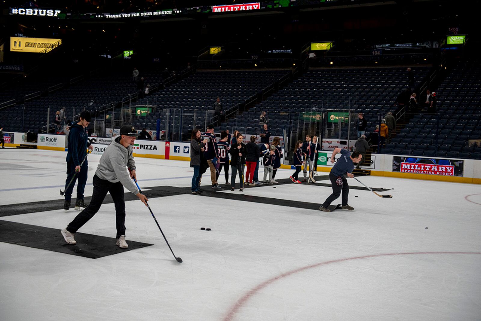 Fans and military veterans take the ice to hit slap shots April 7 following the game between the Columbus Blue Jackets and Philadelphia Flyers at Nationwide Arena. U.S. AIR FORCE PHOTO/SENIOR AIRMAN JACK GARDNER