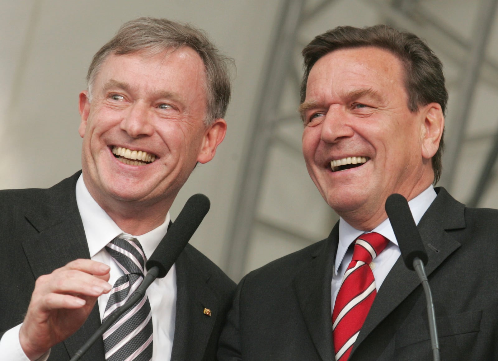 FILE - German President Horst Koehler, left, and German Chancellor Gerhard Schroeder smile as they attend the opening ceremony of the 30th German Protestant Church Meeting in Hanover, northern Germany, on Wednesday, May 25, 2005. (AP Photo/Joerg Sarbach, File)