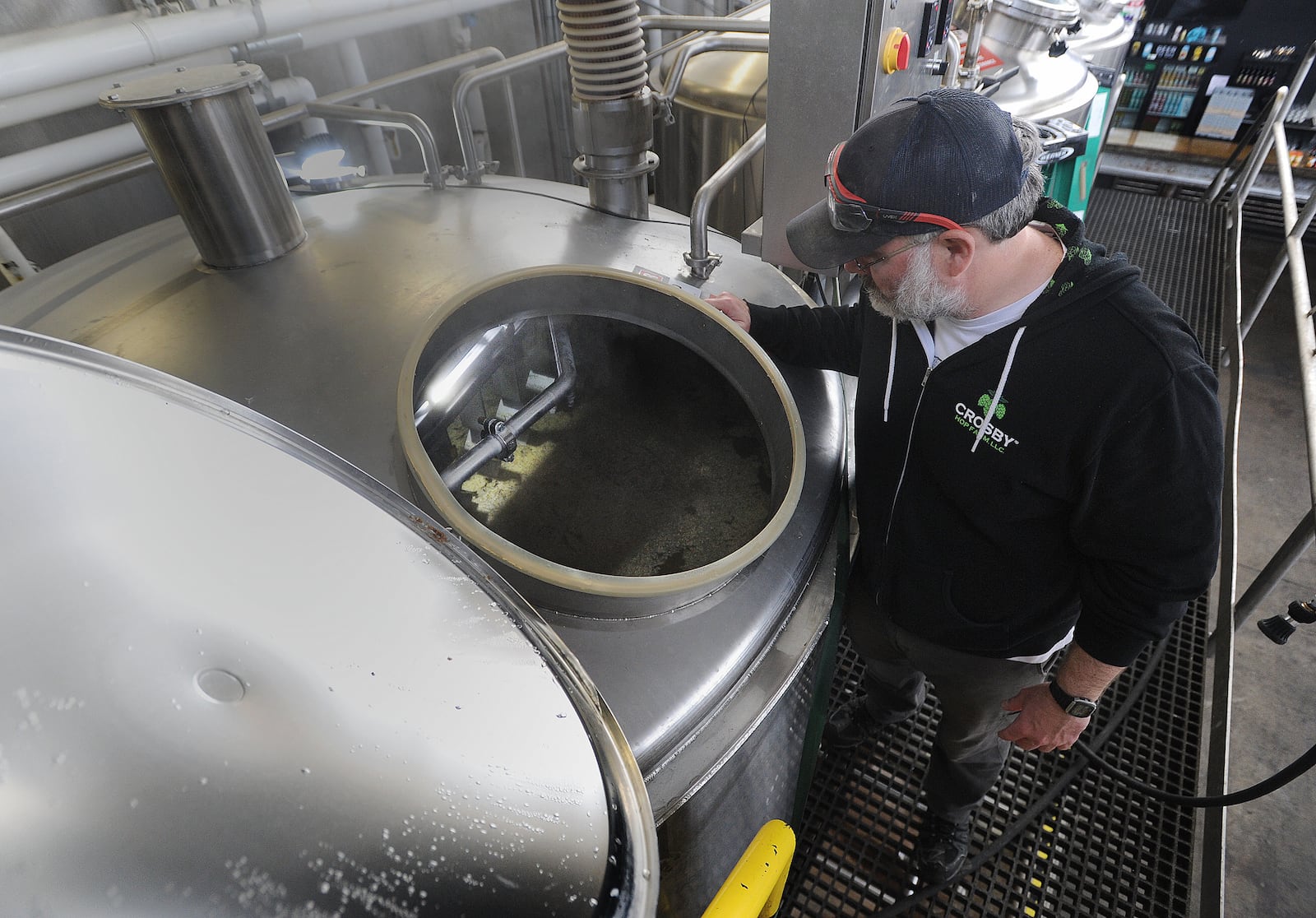 Fred Pallant, the Head Brewer for Warped Wing Brewing Company, checks one of the tanks Wednesday. April 21, 2021. Ohio craft breweries moved up one spot to fifth place in overall craft beer production nationwide. MARSHALL GORBY\STAFF