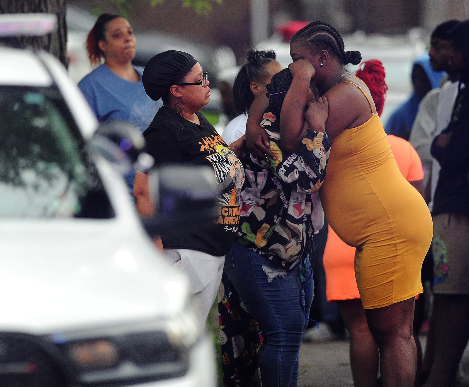 Family and friends grieve at the site of a double fatal shooting on Shaftesburg Road Wednesday, May 22, 2024. A woman and teen boy were killed inside a house. MARSHALL GORBY\STAFF