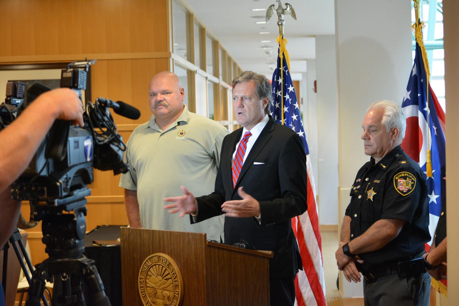 Congressman Mike Turner at a press conference Monday with retired Wright-Patterson firefighter Roy Colbrunn and Montgomery County Sheriff Phil Plummer, who is also chair of the Montgomery County Republican Party. Photo by Jim Otte.