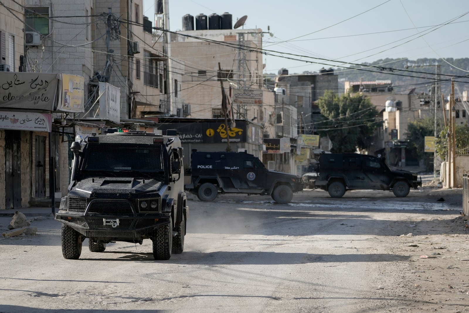 Armored Palestinian security vehicles are seen on the road as Palestinian forces mount a major raid against militants in the Jenin refugee camp in the Israeli-occupied West Bank, Monday, Dec. 16, 2024 (AP Photo/Majdi Mohammed).