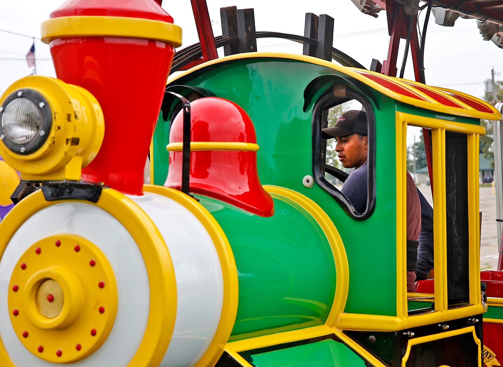 Workers from Durant Amusements unload the train ride on the midway at the Clark County Fairgrounds Tuesday, July 9, 2024. The Clark County Fair starts in 10 days. BILL LACKEY/STAFF