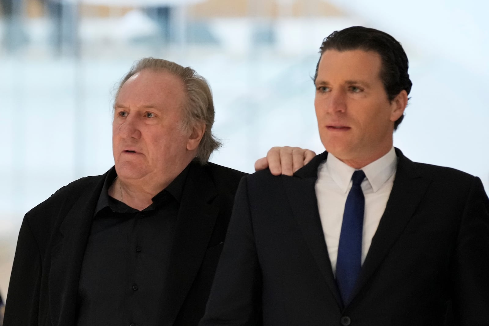 Actor Gerard Depardieu, left, arrives at his trial for the alleged sexual assaults of two women on a film set in 2021, with his lawyer Jeremie Assous ,Tuesday, March 25, 2025 in Paris. (AP Photo/Aurelien Morissard)