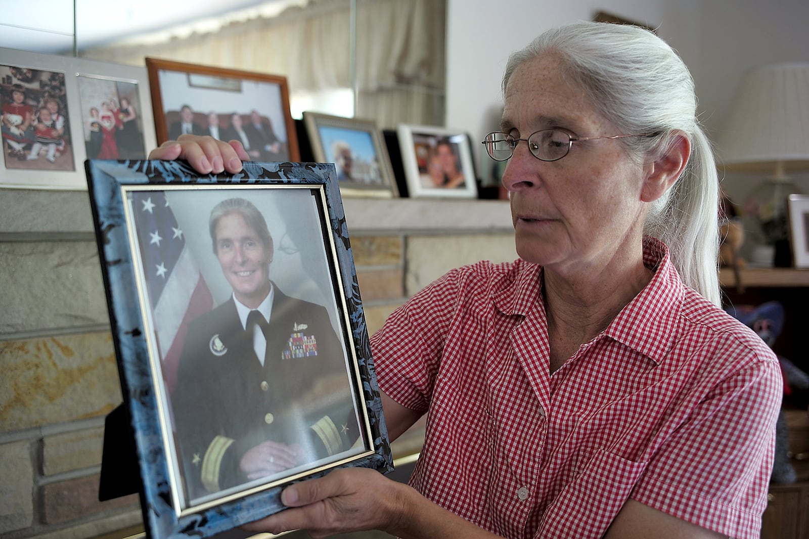 Retired Rear Admiral Deborah Loewer looks over her Navy picture Thursday, Sept. 8, 2016. Loewer was in charge of the White House Situation Room on Sept. 11, 2001. Bill Lackey/Staff