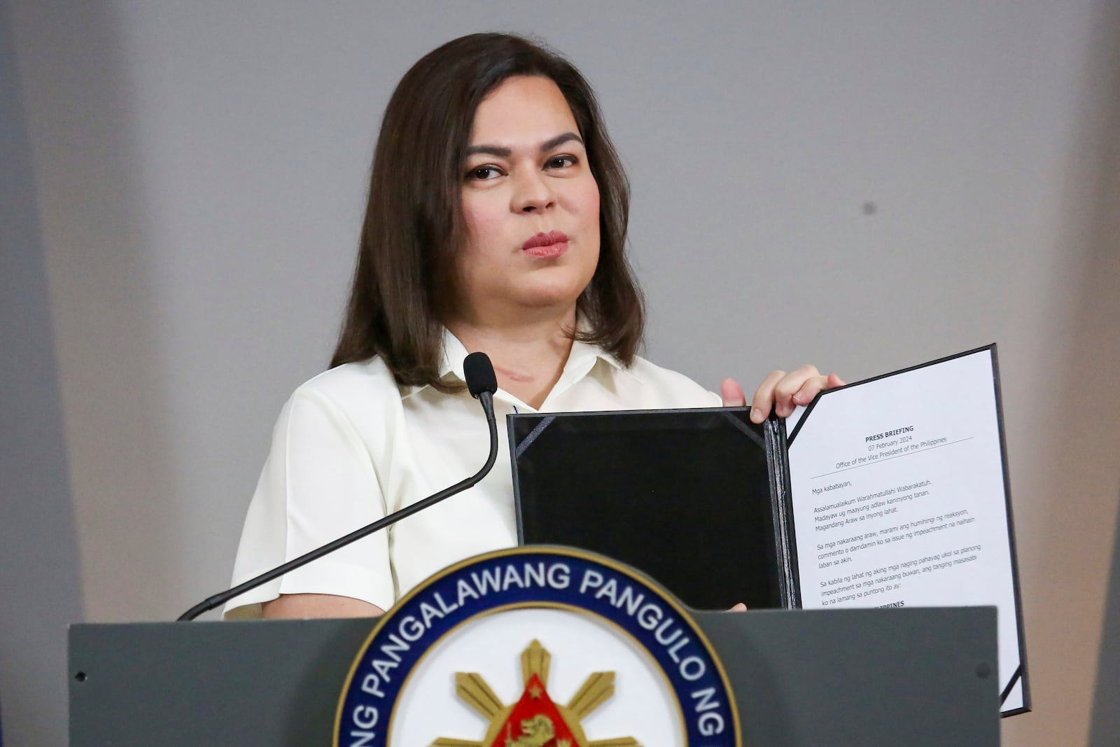 Philippine Vice President Sara Duterte holds a copy of her statement as she speaks during a press conference in Manila, Philippines on Friday, Feb. 7, 2025. (AP Photo/Basilio Sepe)