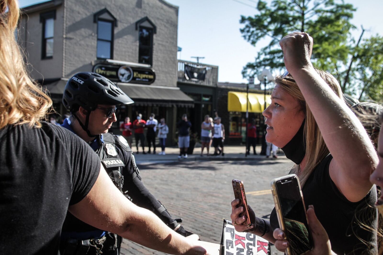 Protestors protest in the Oregon District on Sunday. JIM NOELKER / STAFF