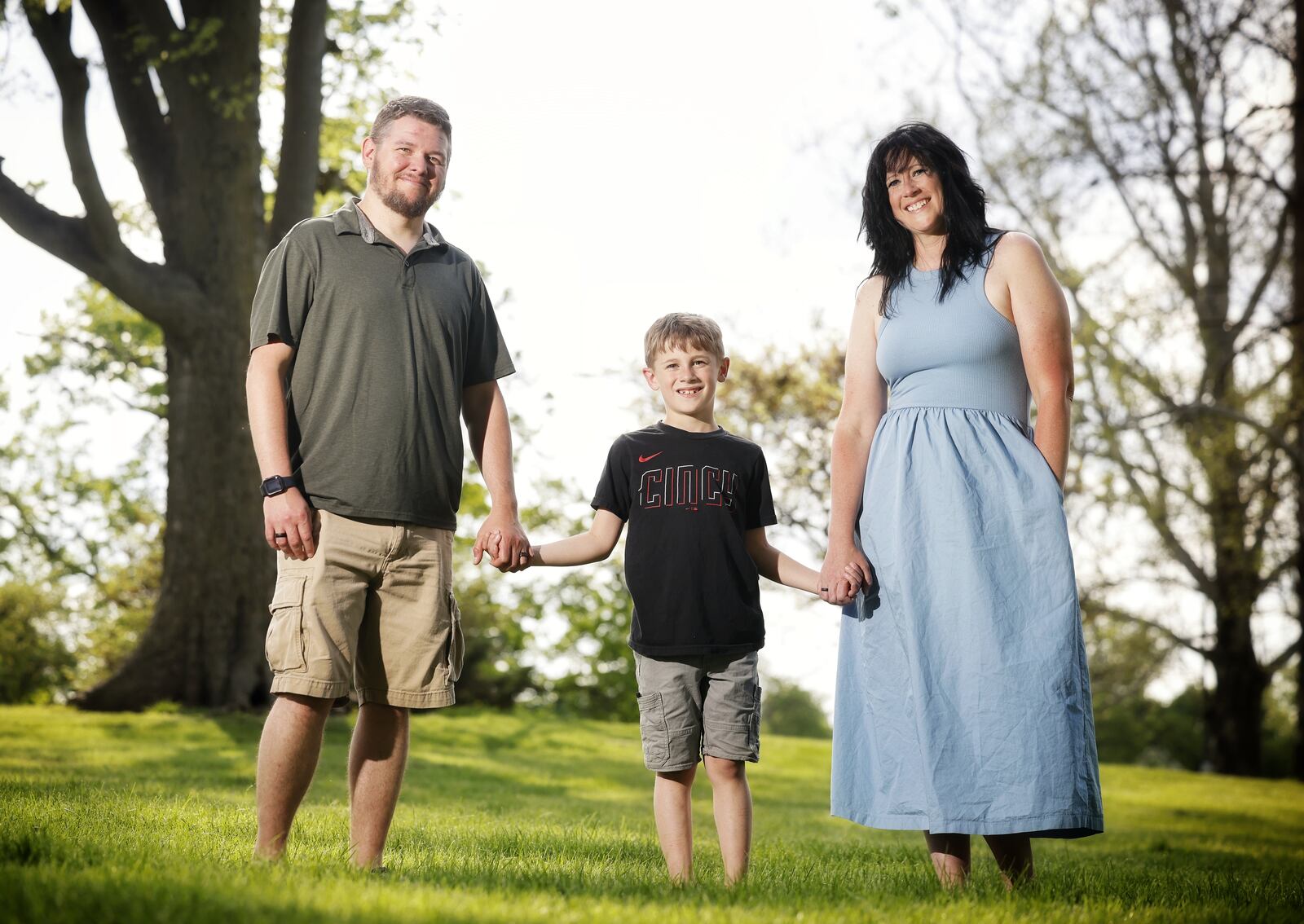 Corey and Kelley Carter stand with their son, Miles, 8, at a park near their home in Middletown. Drug shortages have reached an all-time high this year, and the Carter family has struggled to get the medication they need for their son. NICK GRAHAM/STAFF