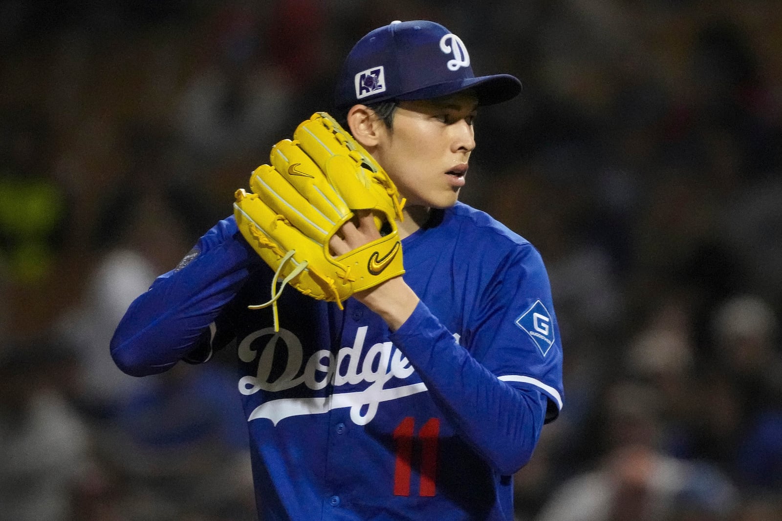 Los Angeles Dodgers pitcher Roki Sasaki (11) throws during the fifth inning of a spring training baseball game against the Cincinnati Reds, Tuesday, March. 4, 2025, in Phoenix. (AP Photo/Darryl Webb)