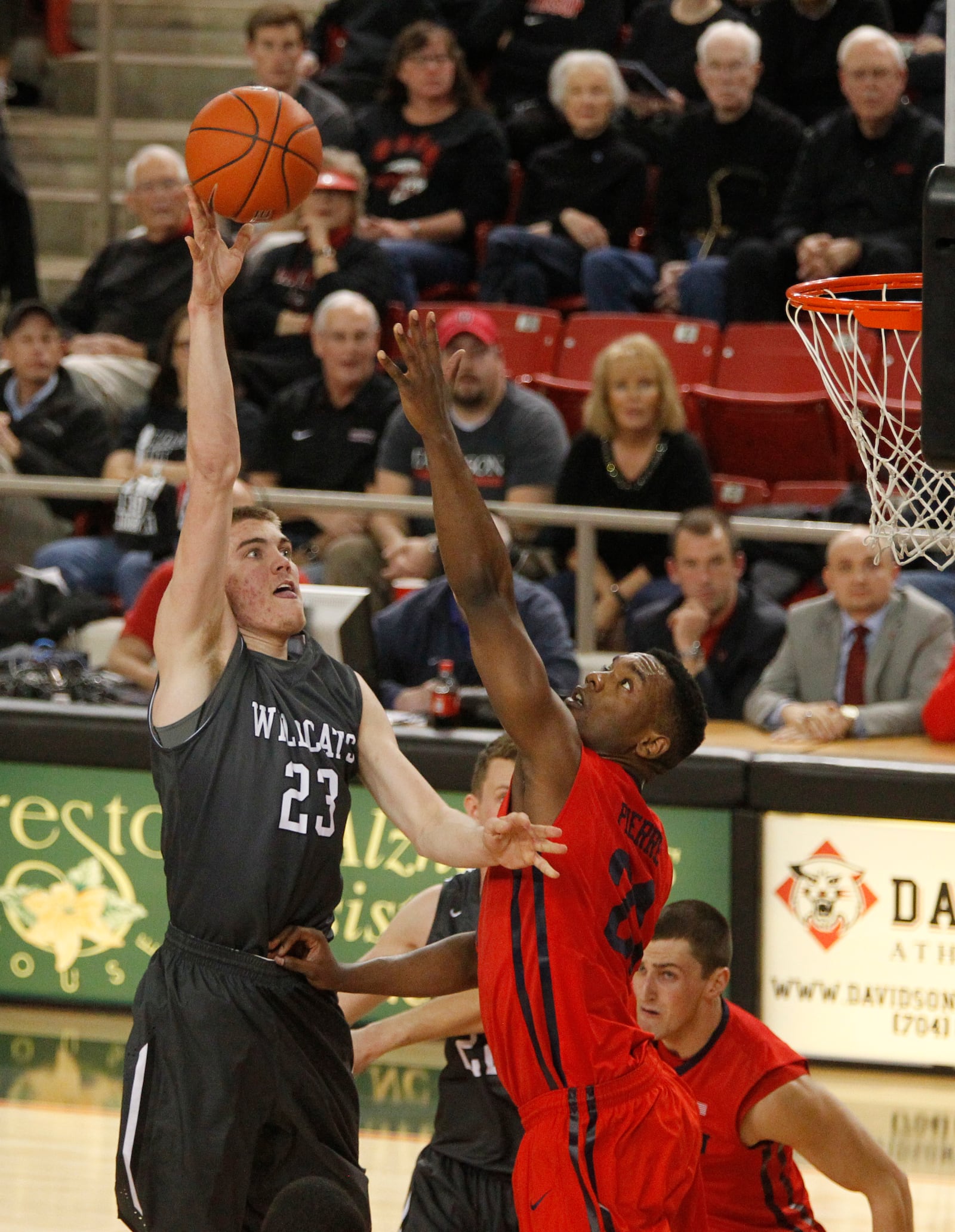 Davidson's Peyton Aldridge, left, shoots over Dayton's Dyshawn Pierre on Tuesday, Jan. 20, 2015, at John M. Belk Arena in Davidson, N.C. David Jablonski/Staff