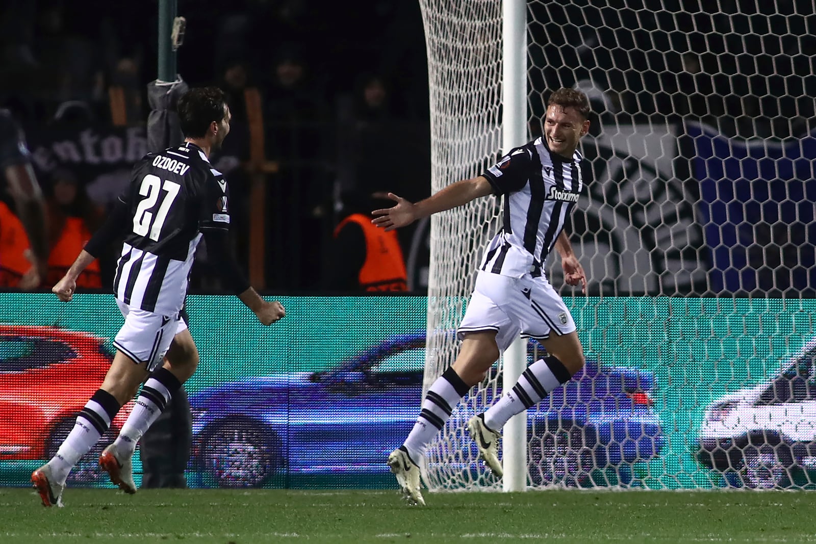 PAOK's Fedor Chalov, right, celebrates after scoring the third goal against Ferencvaros during the Europa League opening phase soccer match between PAOK and Ferencvaros at Toumpa stadium, in Thessaloniki, Greece, Thursday, Dec. 12, 2024. (AP Photo/Giannis Papanikos)