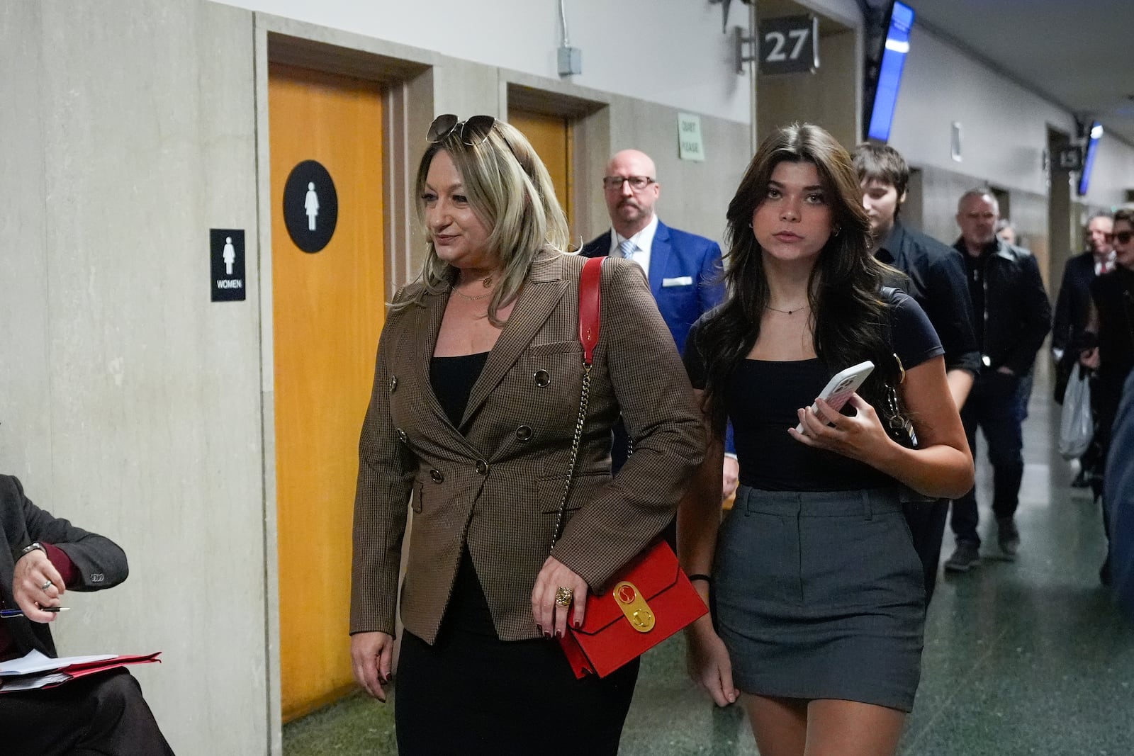 Krista Lee, left, ex-wife of Cash App founder Bob Lee, and other family members walk to Department 28 to enter the courtroom at the Hall of Justice for the murder trial of Nima Momeni, Monday, Dec. 2, 2024, in San Francisco. (AP Photo/Godofredo A. Vásquez)