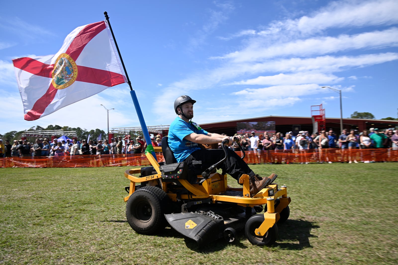 Blake Setser, of Jacksonville, Fla., competes in the lawnmower racing event during the Florida Man Games, Saturday, March 1, 2025, in Elkton, Fla. (AP Photo/Phelan M. Ebenhack)