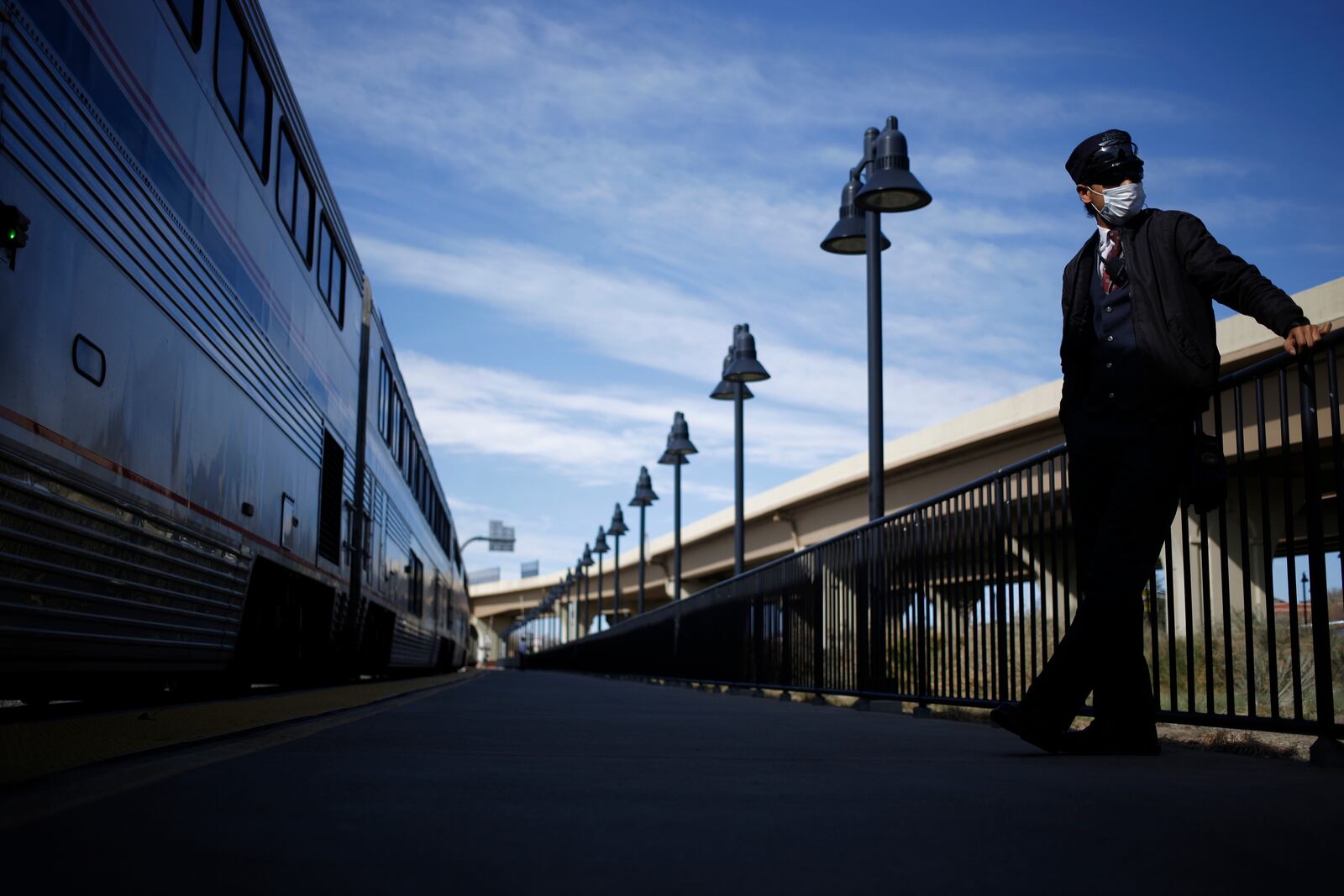 **EMBARGO: No electronic distribution, Web posting or street sales before FRIDAY 3:01 A.M. ET MAY 7, 2021. No exceptions for any reasons. EMBARGO set by source.** FILE -- An Amtrak conductor on a platform in Trinidad, Colo., April 27, 2020. Whether to require vaccines is a delicate decision in which employee health is being considered against personal privacy. Some companies are sidestepping the issue by offering incentives to those who get shots. (Luke Sharrett/The New York Times)