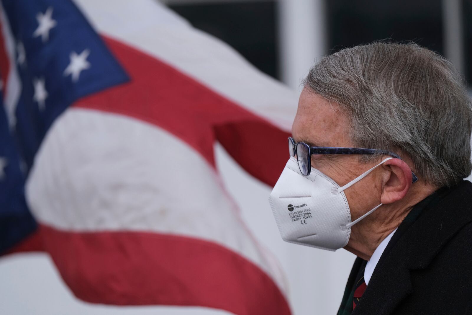 FILE-This Wednesday, Nov.18, 2020 file photo shows Ohio Gov. Mike DeWine looking on during a press conference at Toledo Express Airport in Swanton, Ohio. DeWine is facing criticism from some Republicans over his handling of the pandemic, including statewide mask orders and a ban on alcohol sales after 10 p.m., leading to speculation he could face a primary challenger in 2022. (J.D. Pooley/Sentinel-Tribune via AP)