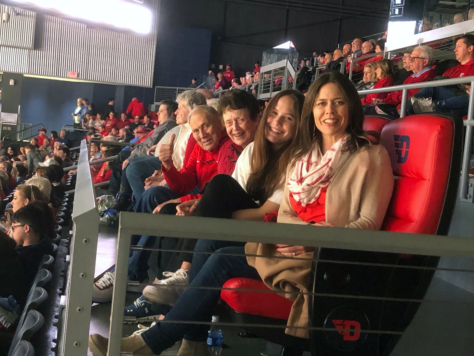 Schaefer's parents, Carmen and Ann Riazzi, set examples of selflessness and sacrifice for their ten children. Carmen played basketball for the University of Dayton from 1954-1957. They are shown attending a UD game with Schaefer's daughter Annie. Left to right Carmen, Ann, Annie and Schaefer. CONTRIBUTED

