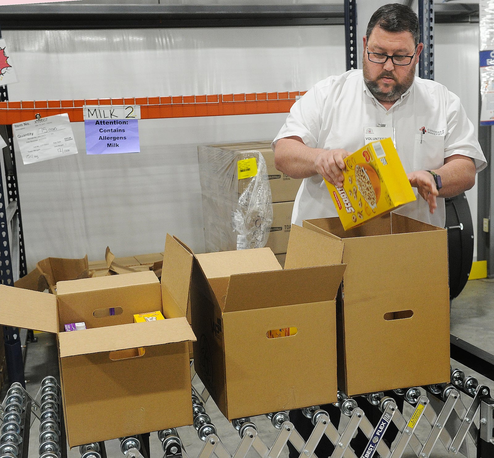 Volunteer Matt Daniels packs boxes for a program that provides food to seniors. MARSHALL GORBY\STAFF