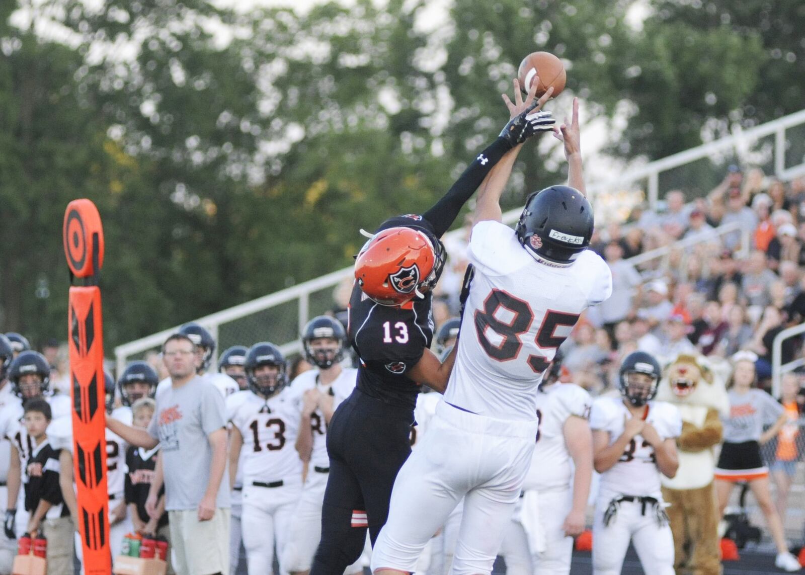 Minster’s Cody Frericks (right) out-wrestles Owen Dorsten of Coldwater to make a long first-half catch. Coldwater defeated visiting Minster 31-20 in a Week 4 high school football game on Friday, Sept. 14, 2018. MARC PENDLETON / STAFF