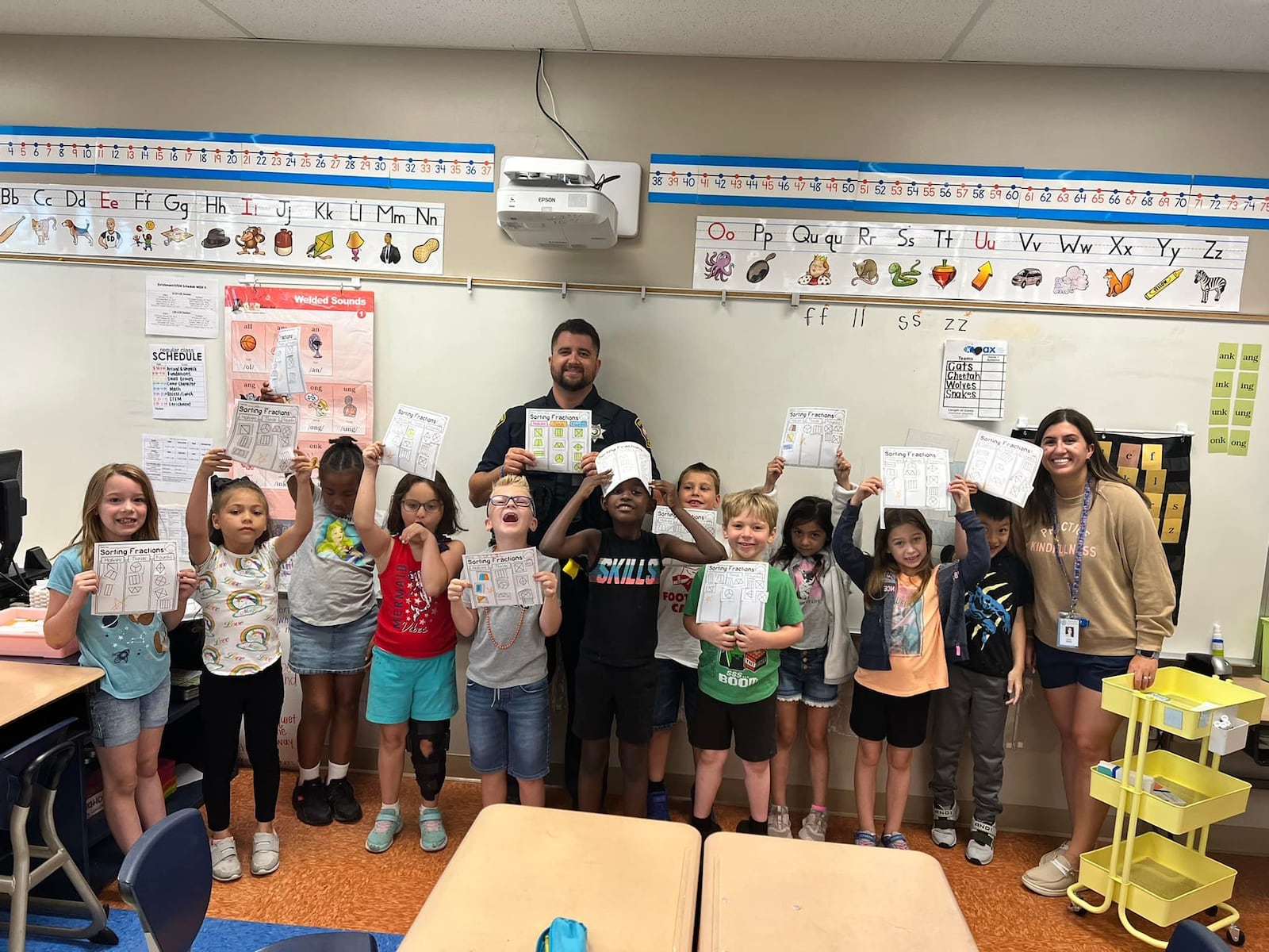 Riverside Police Officer Officer Nick Toscani poses with a classroom of students. Toscani is the district's new student resource officer. Courtesy of Mad River Schools.