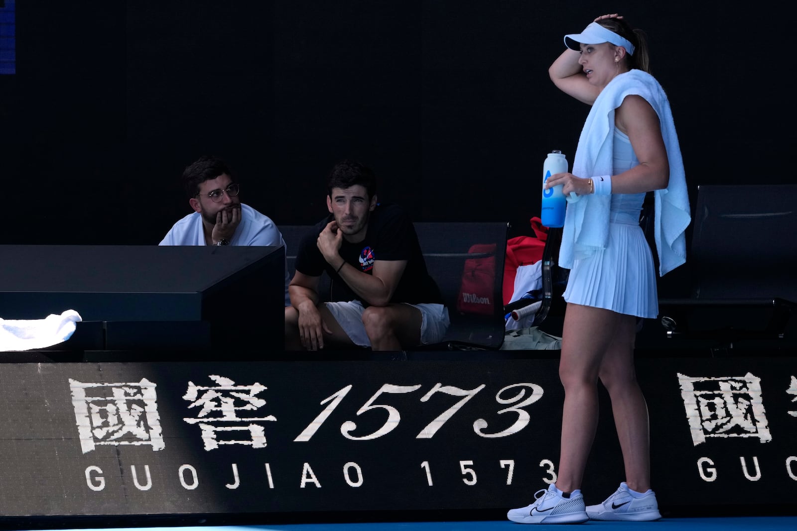 Paula Badosa of Spain talks with her coaches during her quarterfinal match against Coco Gauff of the U.S. during their quarterfinal match at the Australian Open tennis championship in Melbourne, Australia, Tuesday, Jan. 21, 2025. (AP Photo/Manish Swarup)