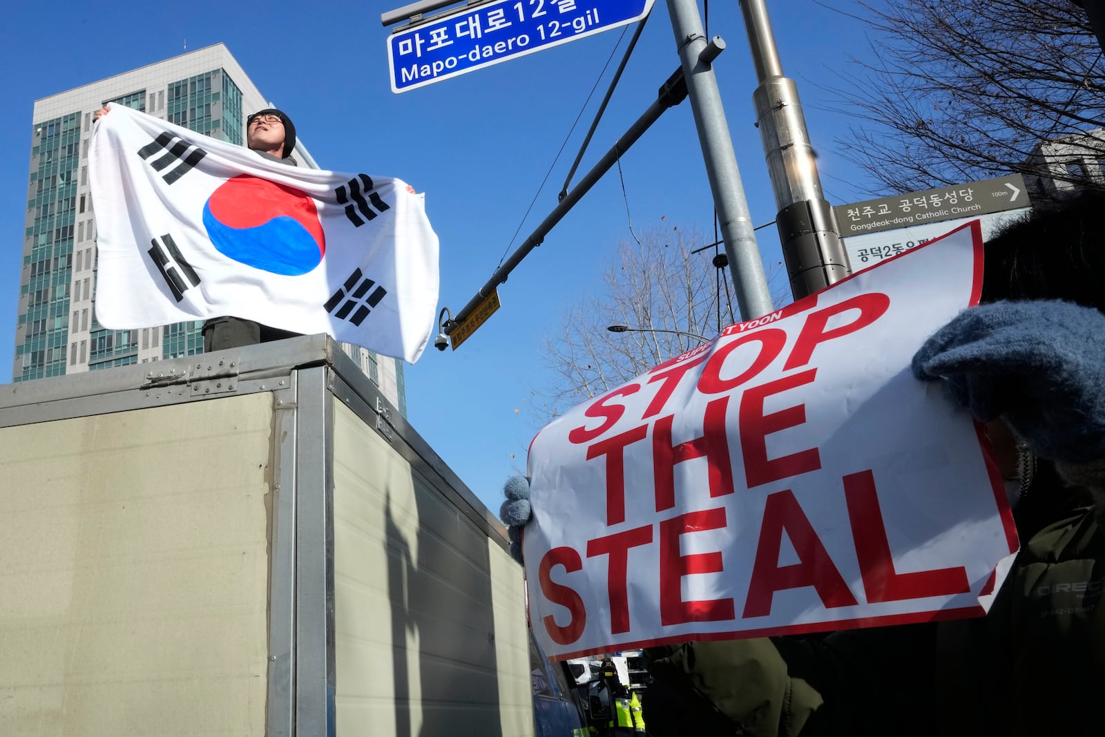 A supporter of impeached South Korean President Yoon Suk Yeol attends a rally to oppose his impeachment outside the Seoul Western District Court in Seoul, South Korea, Saturday, Jan. 18, 2025. (AP Photo/Ahn Young-joon)