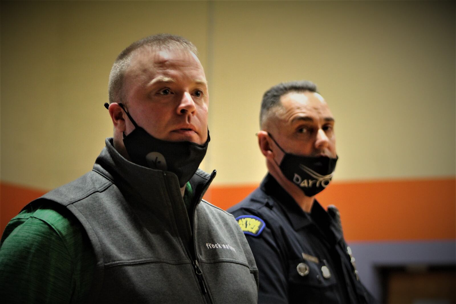 Dayton police officer Dan Mamula (right), the West Patrol Operations Division community engagement officer, and Rick Lombardo, with Flock Safety, at a recent community meeting. Mamula and Lombardo answered questions about Flock's automated license plate readers. CORNELIUS FROLIK / STAFF